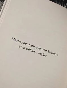 an open book with the words maybe your path is harder because your calling is higher