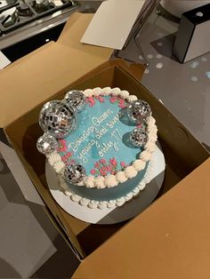 a blue and white birthday cake in a box