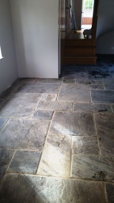 an empty room with stone flooring in it