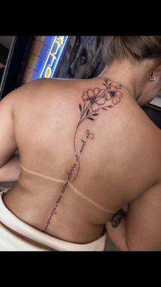 a woman with a tattoo on her back