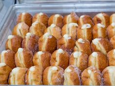 a tray filled with lots of doughnuts covered in icing