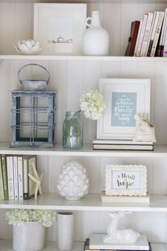 a shelf filled with books and vases on top of it