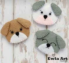 three felt animals are hanging on a white wooden wall with the words ewlla art written below them