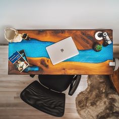 a wooden desk with a laptop and other items on it, along with a fur rug