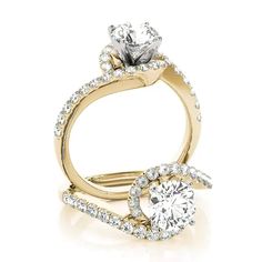 a gold engagement ring with two diamonds on it