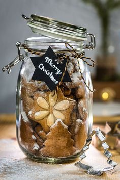 a glass jar filled with cookies on top of a table