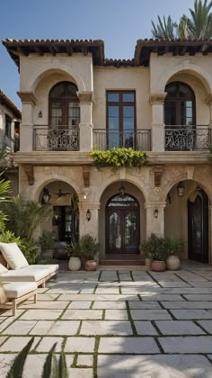 a large house with lots of windows and plants