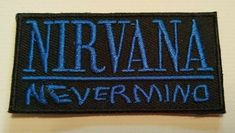 a black and blue embroidered badge with the words nirvana never living on it's side