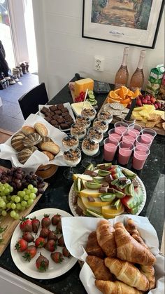 a table filled with lots of different types of food on plates and cups next to each other