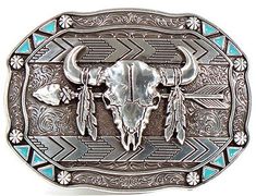 Skull, Feather & Arrow Belt Buckle This rectangle Nocona men's western buckle is definitely a head turner. Engraved floral pattern with a bull skull with an arrow and feathers that are hanging from the horns. Outer edges have small turquoise triangles in each corner and a floral pattern in between. Details: Nocona Mens Buckle Measures: 2-1/2 x 3-1/2 Rectangle Engraved Floral Pattern Bull Skull Design Western Picture Frames, Feather Arrow, Belt Clips, Smith And Western, Western Sculpture, Western Rings, Western Bracelets, Western Prints, Buffalo Skull