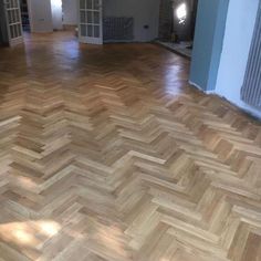 an empty room with wooden floors and hard wood flooring on the side of it