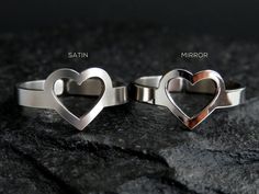 NEW! Dainty heart ring measures just 1 cm in height (top to bottom of heart). The band is 3mm(1/8") wide and is adjustable from the back.FINISH:Choose between Mirror & SatinMATERIAL: High grade Stainless steel* NEVER tarnishes* NO green fingers* Very sturdy* Hypo-allergenic★ QUALITY ★Known for its sturdiness, aesthetic appeal and high resistance to corrosion, stainless steel makes our jewelry ideal for everyday wearing. Our rings will not bend out of shape with long heavy wear and are meant Minimal Ring, Knuckle Rings, Cuff Rings, Valentines Day Gifts For Her, Satin Material, Love Ring, Stainless Steel Rings, Steel Ring, Steel Jewelry