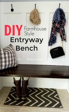 the entryway bench is made from wood and has hooks on it to hold coats