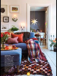 a living room filled with furniture and pictures on the wall