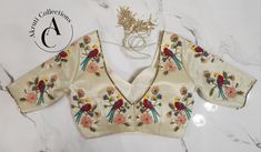 Material: Tissue.
Blouse Size: Can be customized as per your size.
Additional customizations are available such as neckline styles, sleeve lengths, and color choices.
For more details contact us on support@akruticollections.com or WhatsApp +91 9052550550
Price may vary depending on the fabric selection. Luxury Embroidered Fitted Tops, Fitted Motifs Blouse For Reception, Fitted Motif Blouse Piece For Reception, Fitted Blouse With Motifs For Reception, Elegant Silk Tops For Reception, Designer Formal Tops With Floral Embroidery, Designer Embroidered Tops For Formal Occasions, Designer Floral Embroidered Tops For Formal Occasions, Fitted Luxury Silk Blouse