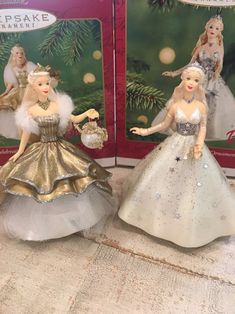 two barbie dolls are shown in front of christmas ornaments