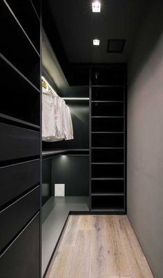 an empty walk in closet with black shelves