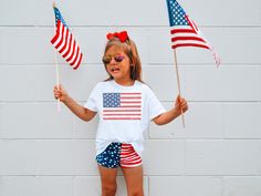 Celebrate the spirit of freedom and showcase your little one's love for their country with our charming Kids' American Flag T-Shirt. Perfect for patriotic holidays, family gatherings, or everyday wear, this t-shirt will make your child the star of any occasion! 🇺🇸 Designed with Love: Our American Flag t-shirt is crafted with utmost care and attention to detail. The iconic stars and stripes design is beautifully printed on premium quality, soft cotton fabric, ensuring comfort and durability for your active little patriot. 🌟 Versatile and Stylish: Whether it's a Fourth of July parade, Memorial Day celebration, or simply an ordinary day filled with American pride, this t-shirt is the ideal choice for your child. It pairs effortlessly with jeans, shorts, or skirts, creating a classic, timel Memorial Day Celebration, Fourth Of July Parade, American Flag Kids, American Flag Tshirt, Ordinary Day, 4th Of July Outfits, Patriotic Holidays, Kids Graphic Tees, Pride Tshirts