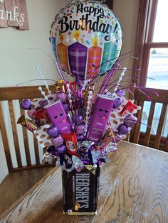 a birthday bouquet with chocolates, candy and balloons