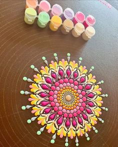 a table topped with lots of different colored paints