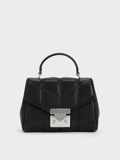 This Eudora top handle bag will easily become your new favourite everyday bag. With a unique chevron quilted pattern, the plush and soft exterior will instantly elevate any look with visual interest. Fitted with silver-toned hardware that stands out against the black finish, the silver-and-black colourway exudes a cool and modern vibe. Carry it by the top handles or simply attach the shoulder strap to go hands-free. Formal Quilted Top Handle Bag, Modern Quilted Bag For Formal Occasions, Modern Quilted Satchel Shoulder Bag, Modern Quilted Top Handle Bag, Modern Quilted Crossbody Bag, Trendy Quilted Top Handle Bags, Chevron Quilt Pattern, Chevron Top, Brand Collaboration