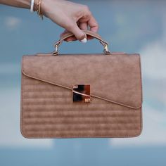 This bag is fancy and casual in all the right ways! If you're looking for a bag for everyday use, this is your girl! 

- Exterior clip lock, released by one push of a button
- Interior slip pocket
- Interior zipper pocket
- vegan leather
- approximately 10 x 7 x 3 inches Boxy Bags, Your Girl