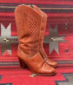 From Blackbird Vintage of Sedona, Arizona  This is a great pair of Vintage Ladies brown leather Boots,size 6.5, and maybe best for a narrow foot. Made In Brazil, circa 1970s. they have a great woven leather design and convenient side zipper closures for easy on/off. Tacco leather insoles which are made in Germany. They are in worn vintage condition. Normal signs of wear for their age, such as  scuffing, spotting, nicks and creasing. Wear to the heels and soles. inner heel lining on one boot is puckering a bit. Please look at all photos closely. Unsure of the brand however "Janis" is stamped inside the boot. -Heel height: 3" -Height of boot:13.5", inclusive of heel height -Heel to toe: 9.25" -insole: 9.25 inches -Width, widest part of sole:3.1/8" Please visit our Brick and Mortar location w Brown Leather Heeled Boots For Western-themed Events, Vintage Heeled Boots For Fall Rodeo, Vintage Heeled Boots For Rodeo In Fall, Brown Woven Leather Boots, Brown Woven Leather Boots With Round Toe, Fall Boots With Woven Leather And Round Toe, Fall Woven Leather Boots With Round Toe, Brown Leather Heeled Boots For Western Events, Fall Boots With Woven Leather