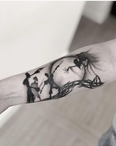 a person's arm with a clock and tree tattoo on the left inner arm