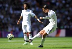 three soccer players in action on the field