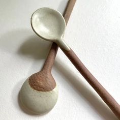 two wooden spoons sitting next to each other