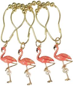 four pink flamingos with pearls hanging from gold colored metal hooks on a white background