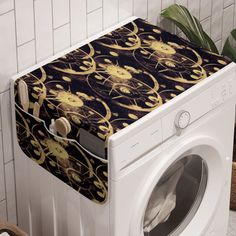 a white washer sitting next to a dryer in a room with tiled walls