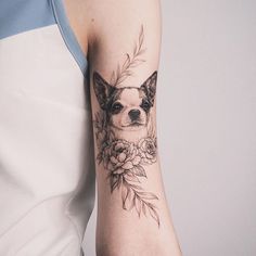 a woman with a dog tattoo on her arm