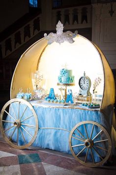 a blue and gold dessert cart with a clock on top