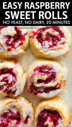 several pastries with white icing and raspberry filling on a baking sheet