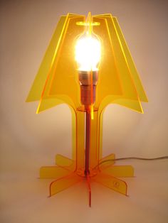 a yellow table lamp with a light bulb on it