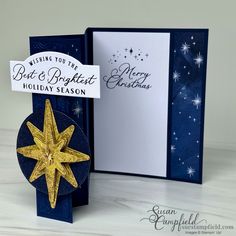 a christmas card with a gold star on it and a blue box that says, wishing you the best holiday season