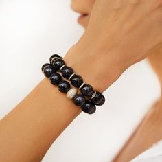 Blue sandstone is known for deflecting negative energy and promoting confidence and success. Sapphire Beaded Lapis Lazuli Bracelets For Gifts, Adjustable Lapis Lazuli Beaded Bracelet With Faceted Beads, Blue Lapis Lazuli Beaded Bracelets, Blue Lapis Lazuli Bracelets With Polished Beads, Blue Crystal Bracelet With Lobster Clasp And Round Beads