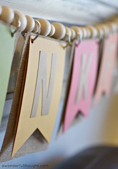 some paper letters are hanging on a clothes line