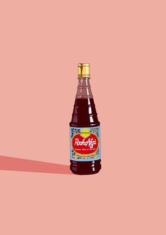 a bottle of soda on a pink background