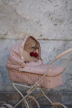 a baby's pram with two red balls in it