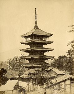 an old black and white photo of a pagoda