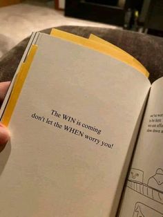 a person holding an open book in their hand while sitting on a couch with the words, the win is coming don't let the when worry you