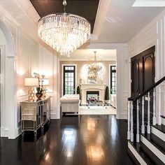 a living room filled with furniture and a chandelier