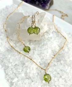 Beautiful August Birthday Gift idea! Peridot Earrings for those August Babies! Checker-board faceted Peridot earrings, in a simple design that show off the beautiful faceting. Hand wrapped to ear wires with gold-filled components. Length 15/16" from top of the ear wire, 8mm Peridot gemstone. Silicon ear backs included. All jewelry comes packaged in gift box with pink organza ribbon. Care instructions also included. Peridot Bracelet, August Birthday, Peridot Pendant, Peridot Earrings, Peridot Necklace, August Birthstone, Organza Ribbon, Chain Links, Peridot Gemstone