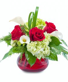 a vase filled with red roses and white flowers