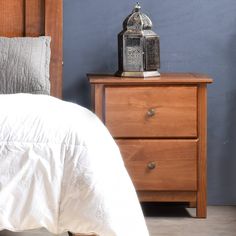 a bedroom with a bed, night stand and nightstand