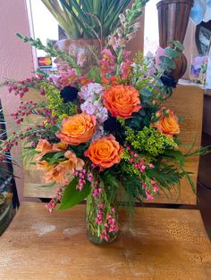 a vase filled with flowers on top of a wooden table