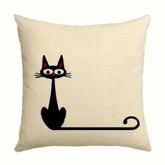 a pillow with a black cat sitting on it's back and eyes drawn onto the side