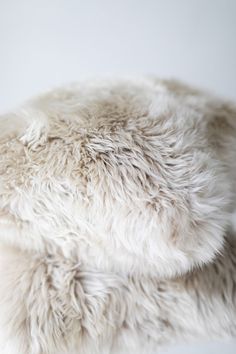 a white sheepskin rug is laying on the floor